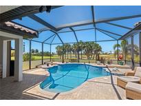 Inviting screened-in pool area with views of the golf course and lush landscaping at 4001 La Costa Island Ct, Punta Gorda, FL 33950