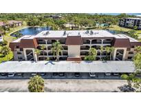 Attractive multi-story condominium building with a pond, and covered parking at 23465 Harborview Rd # 842, Port Charlotte, FL 33980
