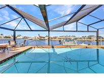 Relax by the pool inside the screened lanai with great views of deep water canal at 4178 Rose Arbor Cir, Port Charlotte, FL 33948