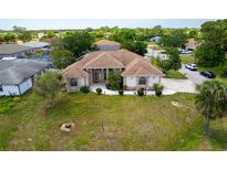 Expansive aerial view of home on spacious lot with manicured lawn and meticulously maintained landscaping at 8315 Raoul Ave, North Port, FL 34291