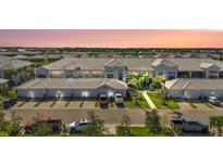 Panoramic aerial view of a condo building featuring multiple units, well maintained landscaping, and plenty of parking at 14204 Heritage Landing Blvd # 712, Punta Gorda, FL 33955