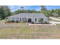 Charming single-story home with well-maintained landscaping and a lush green lawn at 1556 Eagle St, Port Charlotte, FL 33952