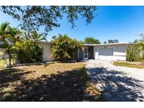 Charming single story home with mature landscaping and a covered entryway, plus attached garage at 182 Dowling Ne Ave, Port Charlotte, FL 33952