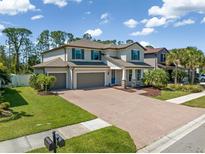 Charming two-story home with a three-car garage and a spacious brick driveway at 2427 Carnation Ct, North Port, FL 34289