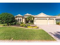Stunning single-story home with a well-manicured lawn, mature trees and a three car garage at 4676 Tuscana Dr, Sarasota, FL 34241