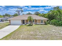 Charming single-story home with a well-maintained lawn and attached two-car garage at 657 Hartford Nw Dr, Port Charlotte, FL 33952