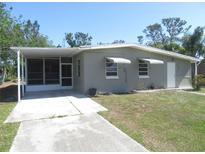 Charming single-story home with a screened carport and cozy curb appeal in a sunny setting at 8544 Herbison Ave, North Port, FL 34287