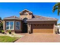 Charming home with a tile roof, a two-car garage and meticulously maintained landscaping in a sunny neighborhood at 10227 Windsong Rd, Punta Gorda, FL 33955