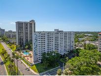 Stunning aerial view of Harbour House condo complex with pool, mature landscaping, and city views at 2401 Bayshore Blvd # 1204, Tampa, FL 33629
