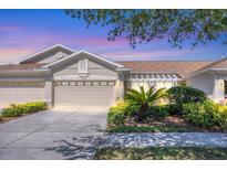 Charming single-story home with a three-car garage, well-manicured landscaping, and a cozy front patio at 2508 Magnolia Cir, North Port, FL 34289