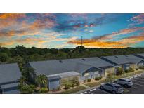 Low aerial view of condo community against colorful dusk sky at 3300 Loveland Blvd # 2801, Punta Gorda, FL 33980