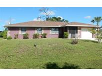 Charming single-story home with a well-maintained lawn and a clean, inviting exterior at 582 Reading Nw St, Port Charlotte, FL 33952