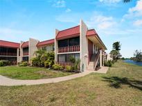 Charming condo building with lush landscaping, private balconies, and a beautiful waterside location at 72 Boundary Blvd # 226, Rotonda West, FL 33947