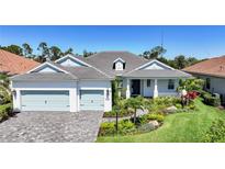 Charming single-story home featuring a three-car garage and lush landscaping at 12472 Davie Ct, Venice, FL 34293