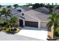 Charming single-story home with a three-car garage and tropical landscaping in a sunny neighborhood at 1677 Palace Ct, Punta Gorda, FL 33980