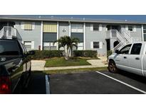 Condo building with lush landscaping, open stairwells and updated exterior paint at 25050 Sandhill Blvd # B3, Punta Gorda, FL 33983