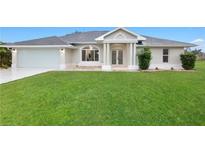 Charming single-story home featuring a well-manicured lawn and attached two-car garage at 2531 Pebble Creek Pl, Port Charlotte, FL 33948