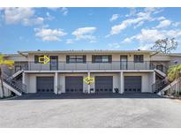 Attractive two-story condo building with private entrances and covered parking spots at 4260 Placida Rd # 13B, Englewood, FL 34224
