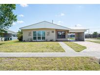Charming single-story home with a well-maintained lawn and covered parking at 6272 Sooner St, North Port, FL 34287