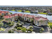 Stunning waterfront condo complex with mature landscaping, red tile roof, and ample parking at 98 Vivante Blvd # 9834, Punta Gorda, FL 33950