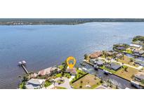 Aerial view of waterfront home with lush landscaping and private dock at 3016 Curry Ter, Port Charlotte, FL 33981