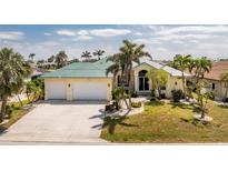 Charming single-Gathering home with lush landscaping, a spacious driveway, and a two-car garage at 1134 Coronado Dr, Punta Gorda, FL 33950