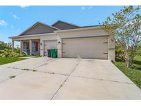 Charming single-story home showcasing a two-car garage and neutral-toned exterior at 15345 Pottstown Ave, Port Charlotte, FL 33981