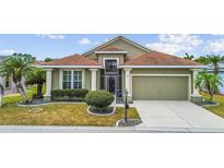 Charming home with a well-manicured lawn, lovely landscaping, and an attached garage at 1673 Palace Ct, Punta Gorda, FL 33980