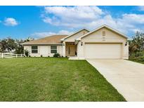 Charming single-story home with well-manicured lawn, neutral exterior, and a two-car garage at 1690 Yakutat Rd, North Port, FL 34287