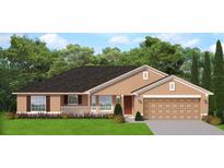 Charming single-story home featuring a covered front porch, a two-car garage, and lush green landscaping at 310 Runyon St, Port Charlotte, FL 33953