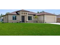 Charming single-story home featuring a well-manicured lawn and attached two car garage at 2186 Florala St, North Port, FL 34287