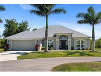 Charming single story home featuring beautiful landscaping and a two-car garage at 27147 Guapore Dr, Punta Gorda, FL 33983
