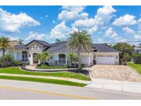 Beautiful single-story home with a paver driveway, tropical landscaping, and a two-car garage at 3866 Turtle Dove Blvd, Punta Gorda, FL 33950