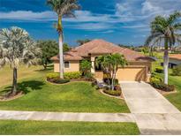 Beautiful single-Gathering home with a well-manicured lawn, lovely landscaping, and a paver driveway at 4015 La Costa Island Ct, Punta Gorda, FL 33950