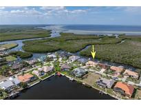 Stunning aerial view of canal-front home with boat dock, lush surroundings, and easy ocean access at 5720 Almar Dr, Punta Gorda, FL 33950