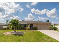 Charming single-story home featuring a well-maintained lawn and inviting curb appeal at 949 Springview Nw Ave, Port Charlotte, FL 33948