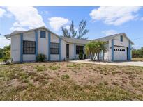 Charming single-story home with a two-car garage and xeriscaped front yard at 453 Carolyn Ln, Punta Gorda, FL 33950