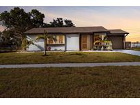 Charming single-story home with well-maintained lawn and tidy landscaping, creating great curb appeal at 5520 Kenwood Dr, North Port, FL 34287