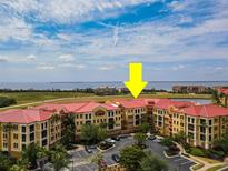 Beautiful aerial view of condos with red tile roofs near a body of water with a bright blue sky at 99 Vivante Blvd # 311, Punta Gorda, FL 33950