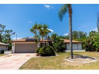 Beautiful single Gathering home with desert landscaping, solar panels and two car garage at 21080 Firwood Ter, Port Charlotte, FL 33954