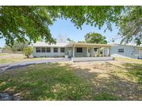 Charming single-story home featuring a covered porch and long driveway at 3515 Vasco St, Punta Gorda, FL 33950