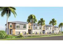 Modern townhome exterior featuring a two-story design, private garage, and tropical landscaping with palm trees at 3609 Bal Harbor Blvd, Punta Gorda, FL 33950