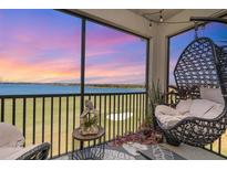 Relaxing patio with comfortable seating and stunning views of the golf course and colorful evening sky at 43050 Greenway Blvd # 645, Punta Gorda, FL 33982