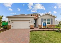 Charming single-story home with a two-car garage, brick accents, and a well-manicured lawn at 1132 Moss Cove Ct, Port Charlotte, FL 33953
