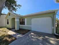 Charming single-story home with an attached garage and well-maintained front yard at 19583 Kapok Ct, Port Charlotte, FL 33952