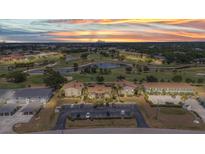 Stunning sunset aerial view of the golf course community with well-manicured landscaping and serene water features at 26336 Nadir Rd # 10, Punta Gorda, FL 33983