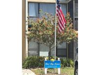 Image of the Bird Bay Leisure office with vibrant flowers and the American flag displayed at 618 Bird Bay S Dr # 109, Venice, FL 34285