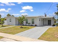 Charming single-story home boasts a well-manicured lawn and convenient carport for covered parking at 6309 Pontiac Ln, North Port, FL 34287