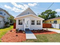 Charming home featuring a well-maintained front yard and a welcoming entrance at 7413 S Elliott St, Tampa, FL 33616