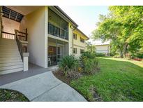 Exterior of home with stairs and outdoor entry, along with landscaped yard at 1515 Forrest Nelson Blvd # N101, Port Charlotte, FL 33952